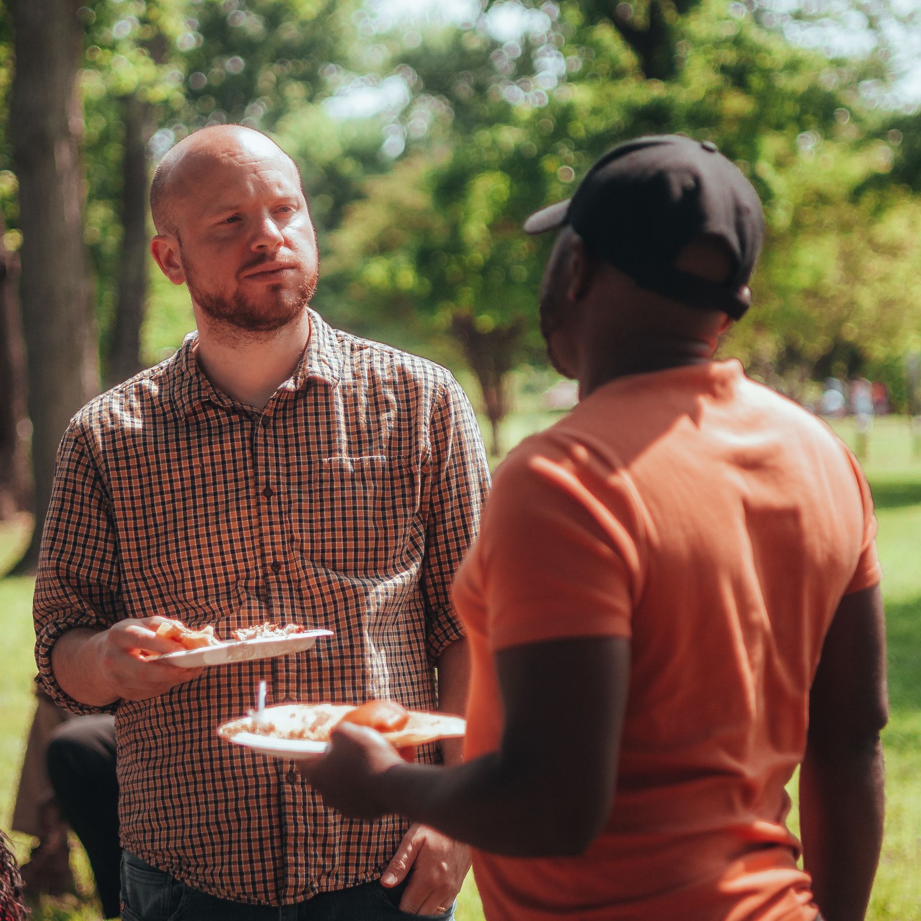 Two neighbours chatting at a garden party